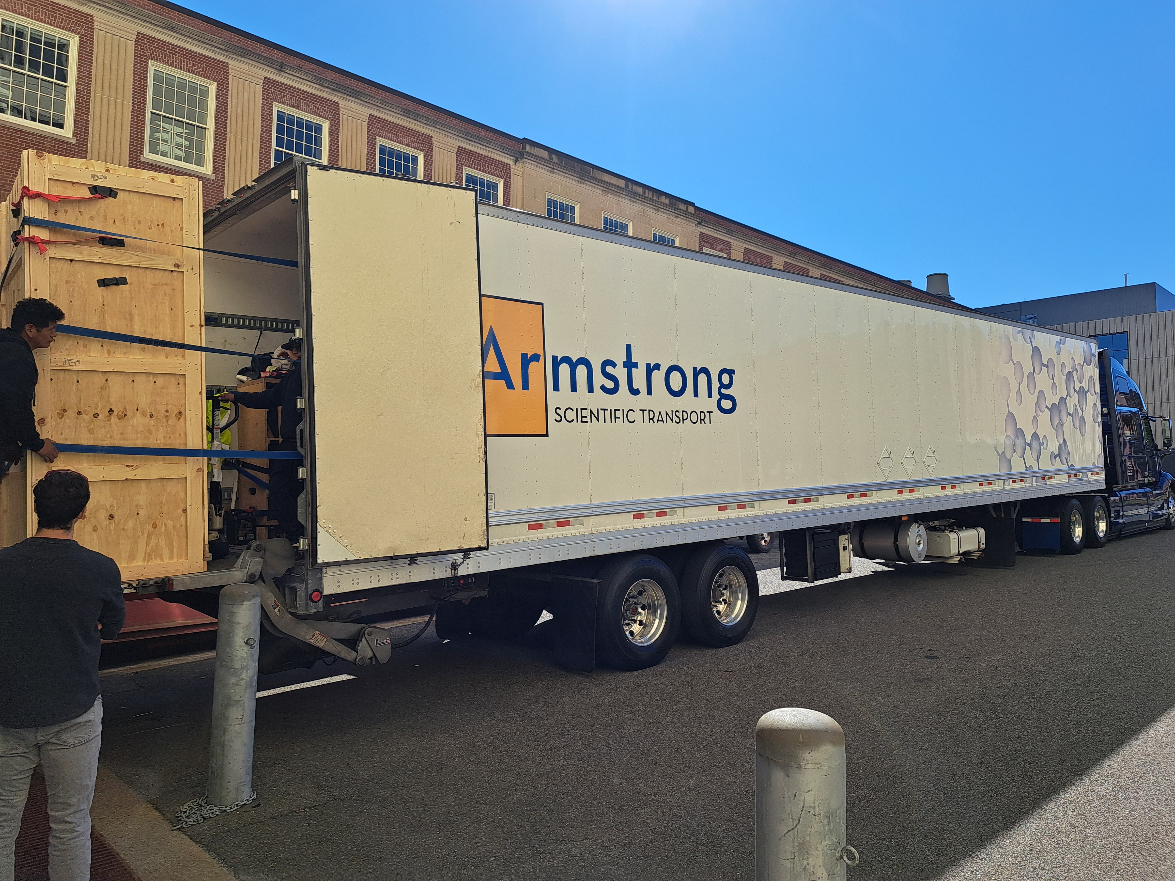 A scientific transport truck and crated lab equipment during the lab move to Toronto.